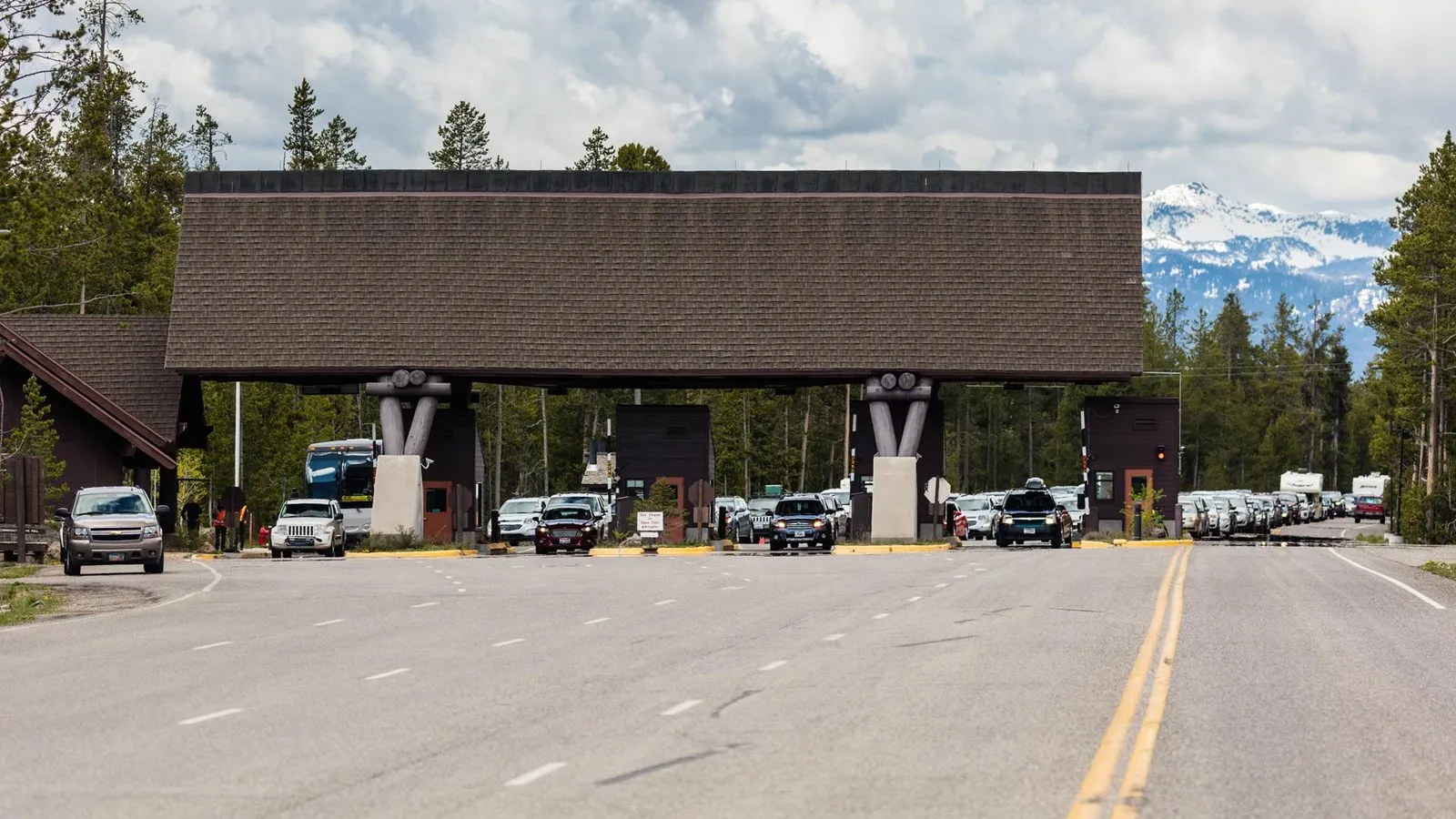 Yellowstone National Park West Entrance station with multiple lanes of traffic