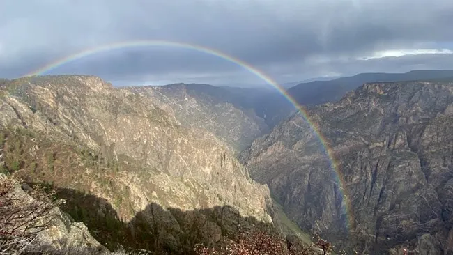 Rainbow over Black Canyon of the Gunnison with storm clouds