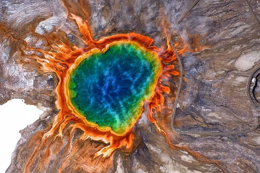 Stunning aerial view of Grand Prismatic Spring in Yellowstone National Park showing the full spectrum of rainbow colors from deep blue center to orange and red edges