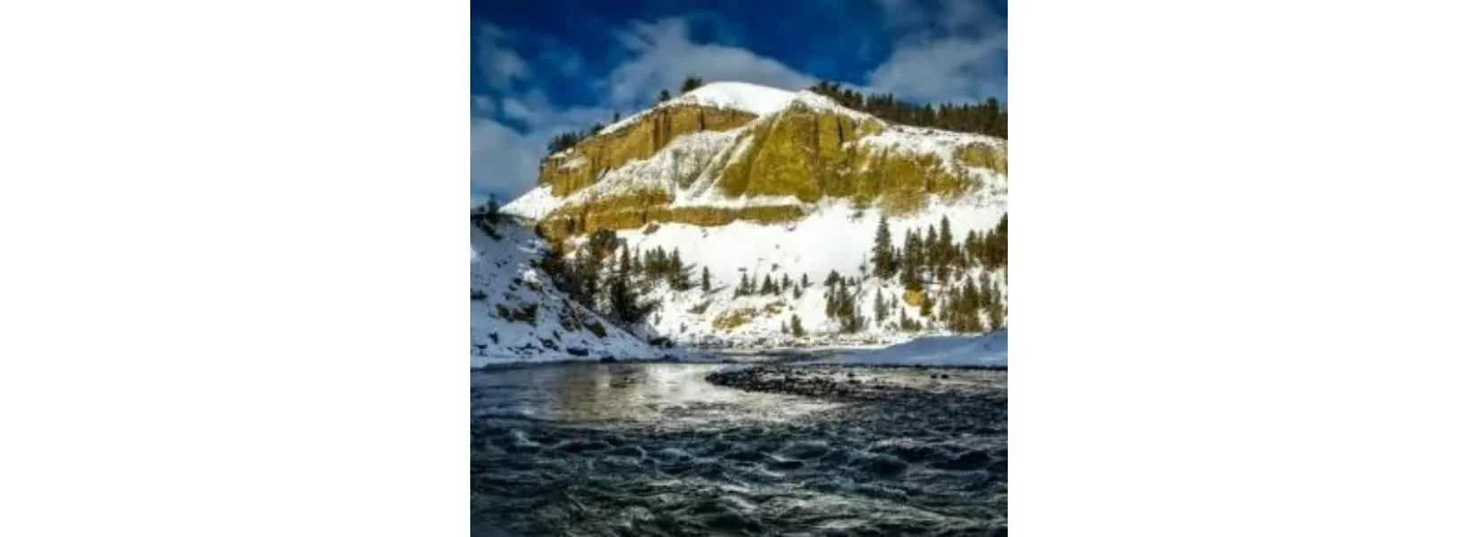Yellowstone National Park river landscape in May showing spring conditions with snow-capped mountains