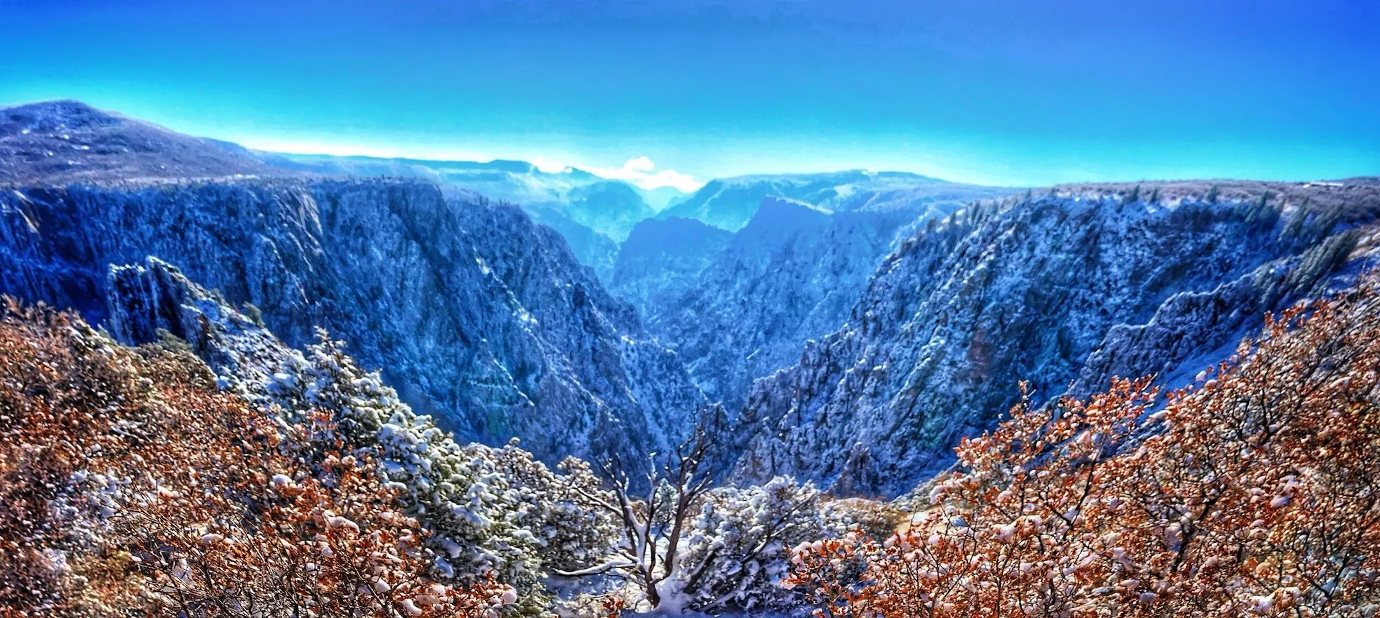 Black Canyon of the Gunnison panoramic view showing dramatic cliff faces and sky