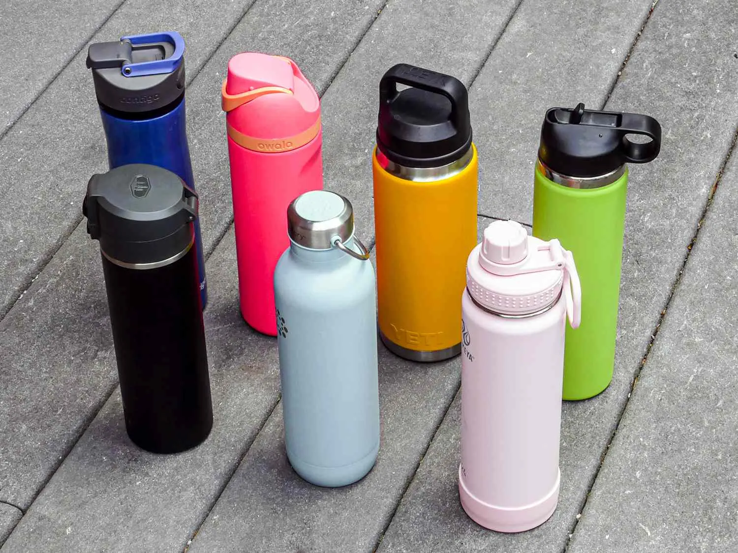 Various stainless steel water bottles including Hydro Flask, Yeti, and other premium brands arranged for comparison