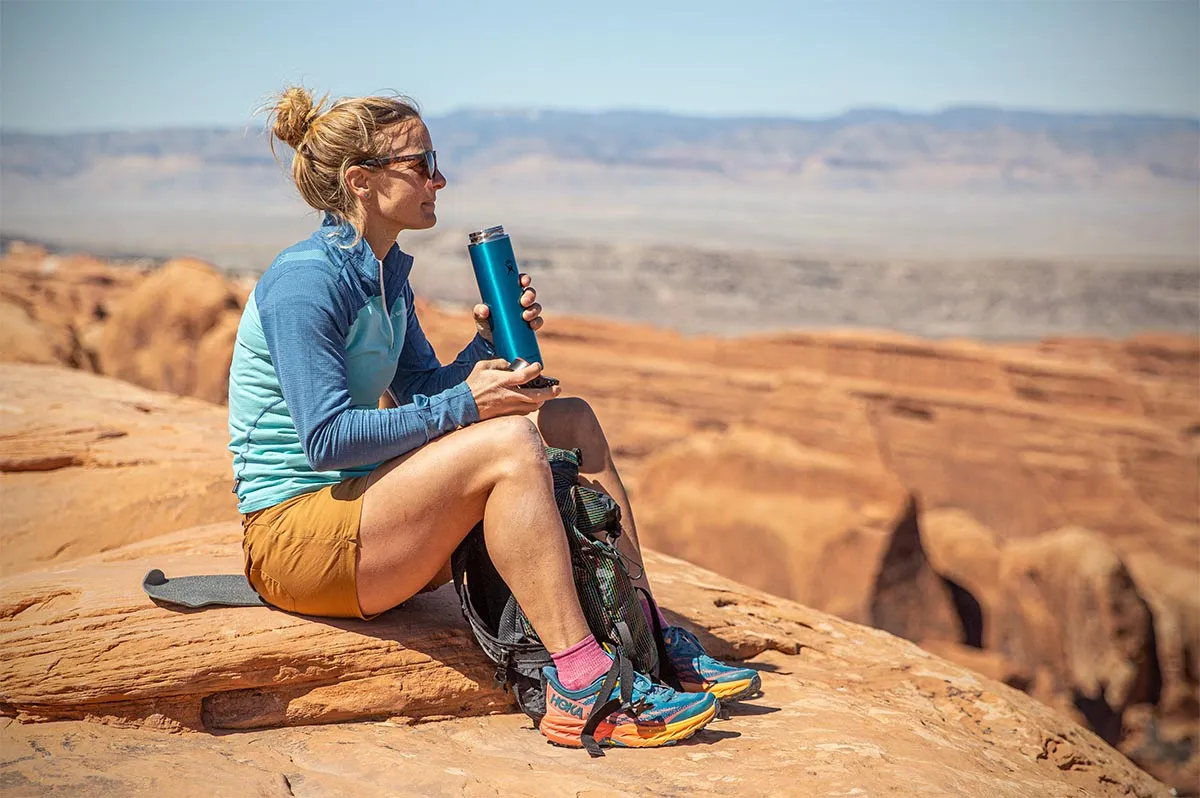 Family using BPA-free water bottles while hiking outdoors in nature